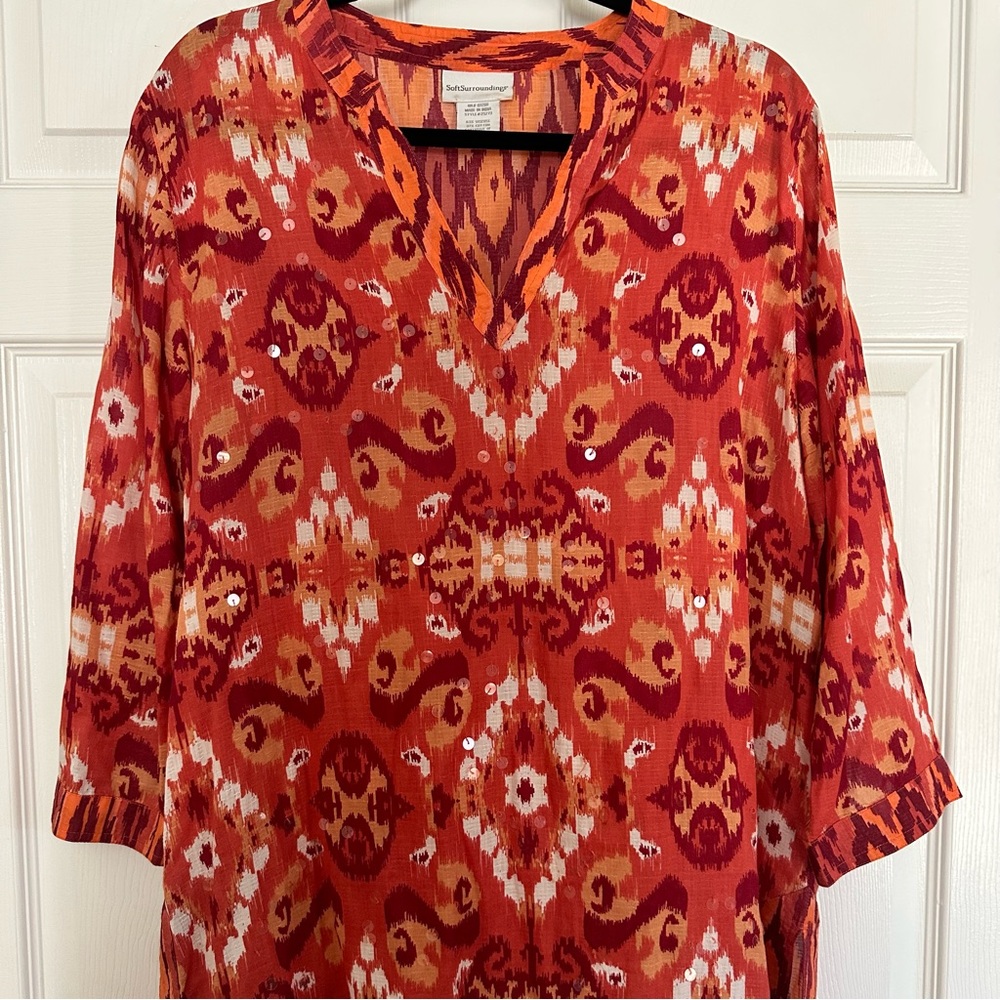 Tunic top,slipon. Abstract design in rich orange hues.Iridescent embellishments.